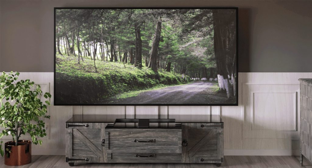 home cinema cabinet that displays an image of a forest path with tall trees